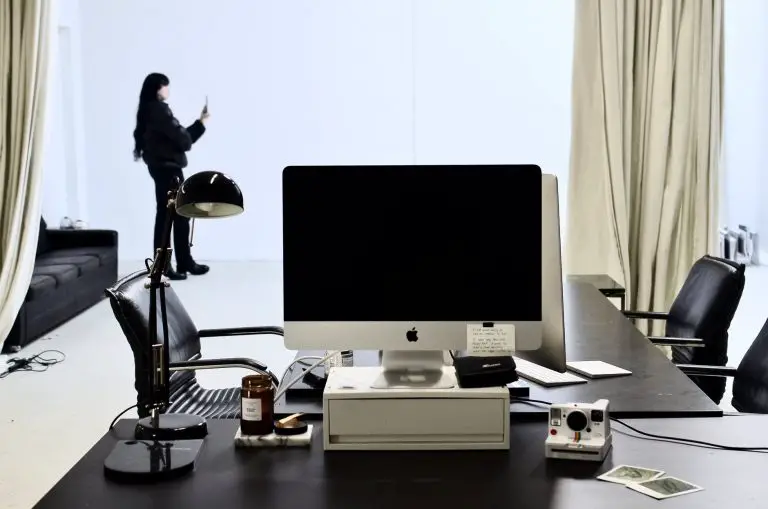 modern workspace with computer and instant photo camera