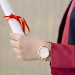 person wearing analog watch