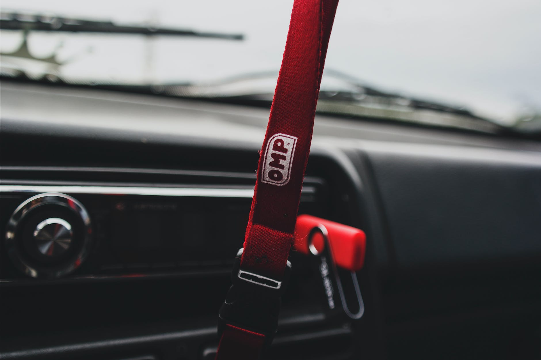 closeup photo of white and red omp lanyard